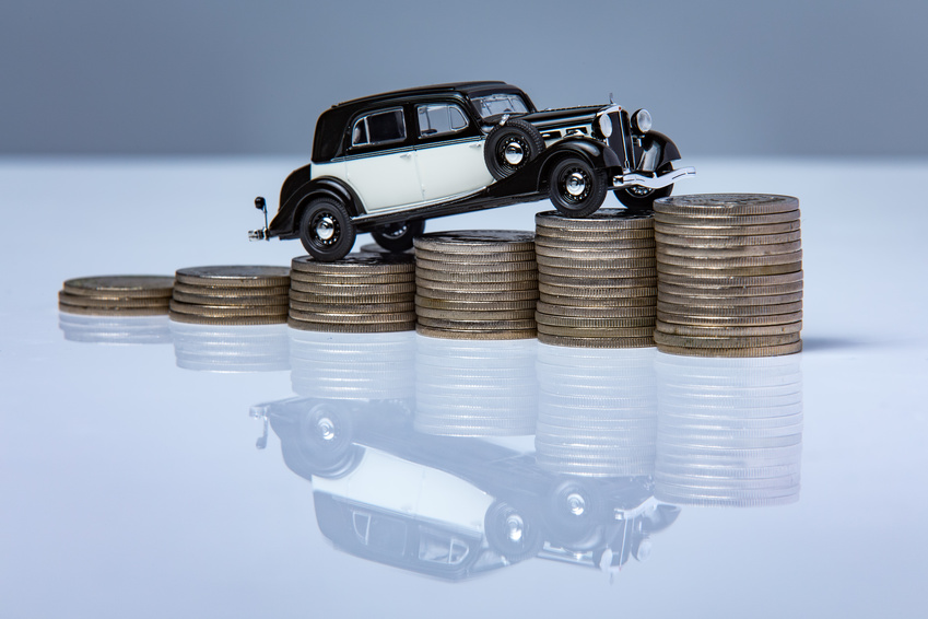 Toy car on top of coins representing Ford finance