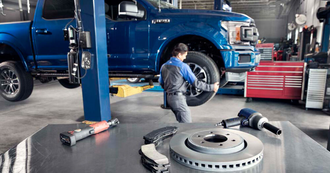 Ford service technician working on brakes