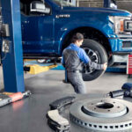 Ford service technician working on brakes