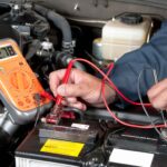 Ford service technician testing a battery