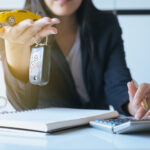 Reviewing Ford financing options with notepad and calculator