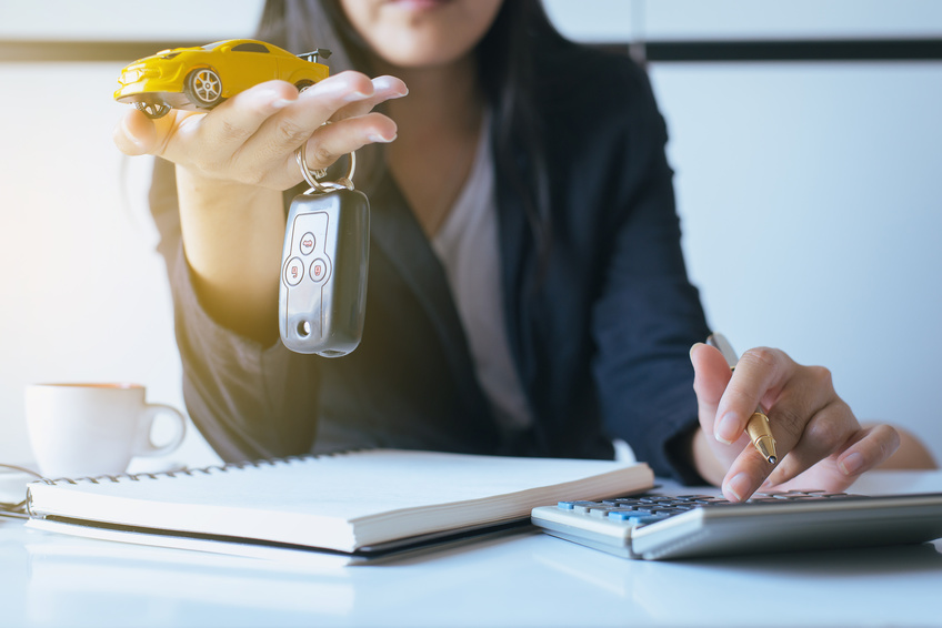 Reviewing Ford financing options with notepad and calculator