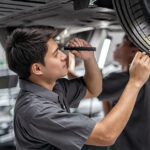 Ford service technician inspecting tire tread